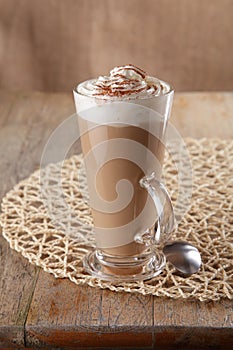 Coffee latte macchiato with cream in glass photo