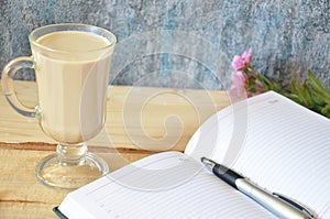 Coffee latte macchiato with cream in glasses on window background, shallow DOF