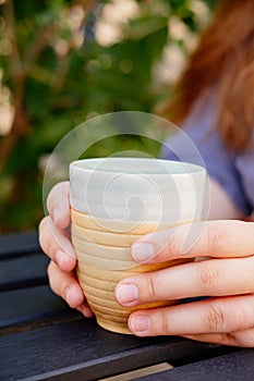 Coffee latte macchiato with mint syrup and whipped cream, on a wooden table of a summer cafe