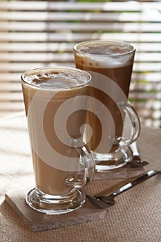 Coffee latte macchiato in tall glasses