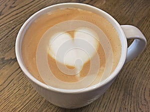 Coffee latte with milk foam designed as heart shape