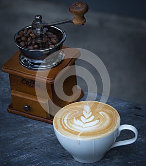 Coffee latte with vintage coffee grinder and coffee bean