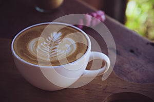 Coffee latte white cup on wood table in cafe coffee shop in the