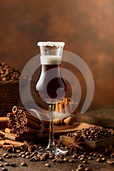 Coffee liqueur with cream on a brown background