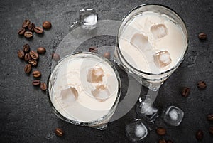 Coffee liqueur in glasses with ice and coffee beans.