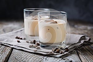 Coffee liqueur in glasses with ice and beans