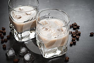 Coffee liqueur in glasses with ice and coffee beans.