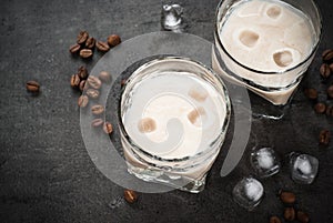 Coffee liqueur in glasses with ice and coffee beans.