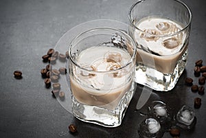 Coffee liqueur in glasses with ice and coffee beans.