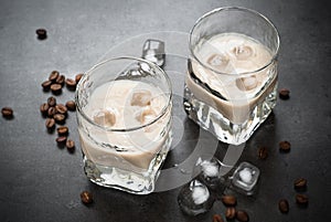 Coffee liqueur in glasses with ice and coffee beans.