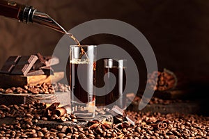 Coffee liquor is poured from a bottle into a glass