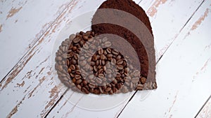 Coffee love.Coffee beans and coffee powder that together form a heart.organic food.