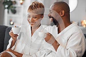 Coffee, love and mature couple on a sofa, happy and laughing while drinking coffee and relax in bathrobe in living room