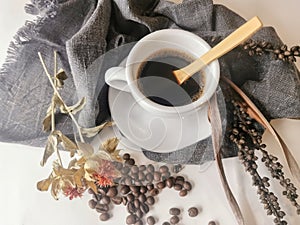 Coffee lovers commercial set, view of espresso cup decorated with roasted coffee beans and dry leaves, decorative elements