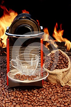 Coffee machine with cup of espresso near fireplace