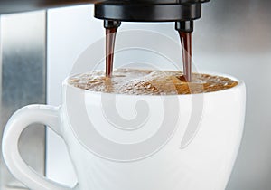 Coffee machine making espresso in white cup