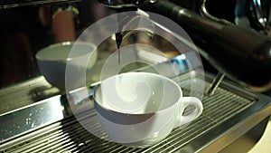 Coffee machine pouring espresso in cup