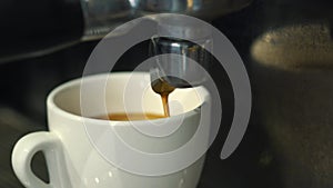 Coffee machine pouring espresso in cup