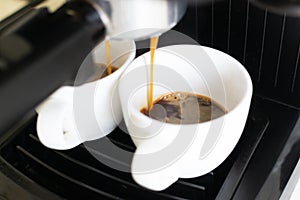 The coffee machine is preparing an espresso.