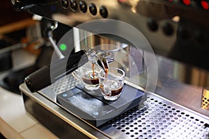 Coffee machine preparing espresso into cups