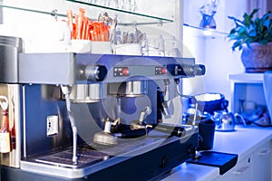 coffee machine preparing fresh coffee and pouring into red cups at restaurant, bar or pub