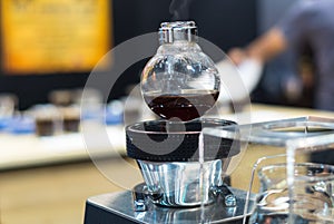 Coffee machine in shop with customer blurred background