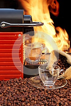 Coffee machine with two cups of espresso and fire background