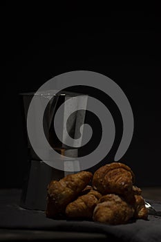 coffee maker and croissants on wooden table