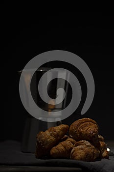 coffee maker and croissants on wooden table