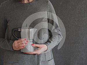 coffee maker held in the hands of a woman