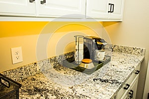 Coffee Maker And Mugs On Portable Tray On Kitchen Granite Counter