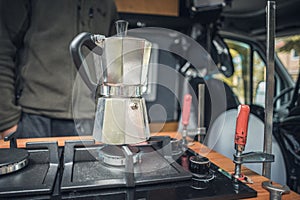 Coffee maker on a newly installed gas stove in a camper van