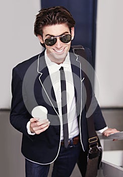 Coffee makes it better. Cropped image of a trendy young man walking up the stairs with coffee.