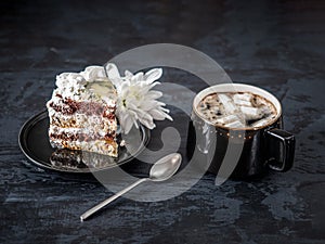 Coffee with marshlelows and a cake with a chrysanthemum flower for a pleasant snack