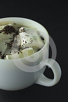 Coffee with marshmallow on a black background