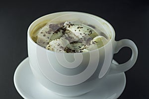 Coffee with marshmallow on a black background