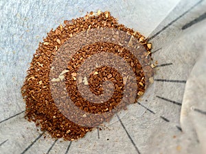 Coffee Medium Fine Grinds with Coffee Filter Paper. Macro Close Up View