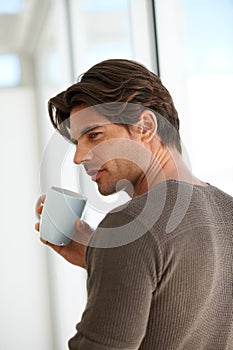 Coffee, memory and young man at apartment with thinking, vision or reflection face expression. Handsome, morning and