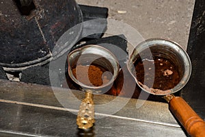 Coffee in metal Turkish traditional cup, being served in a traditional cafe bar in Istanbul, Turkey