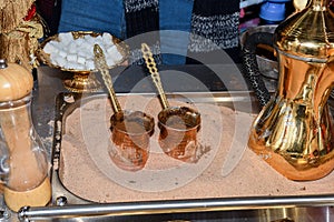 Coffee in metal Turkish traditional cup, being served in a traditional cafe bar in Istanbul, Turkey