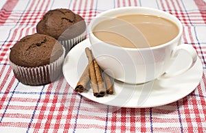 Coffee with milk, cinnamon and muffins