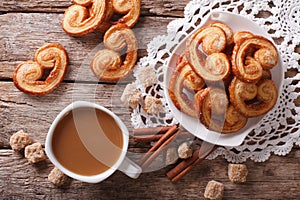 Coffee with milk and cookies Palmiers on the table. Horizontal t photo