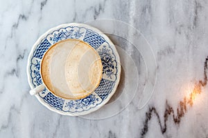 Coffee milk in a cup on marble table.