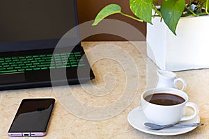 Coffee with milk jug on marble top table.