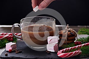 Coffee with milk preparation in glass cup with marshmallow