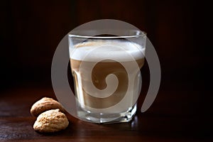 Coffee with milk on rustic wooden background. Soft focus. Close up. Copy space.