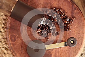 Coffee beans overflowing from the coffee mill