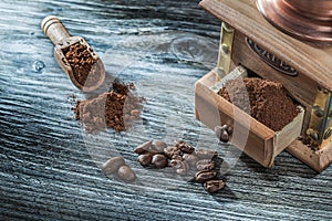 Coffee mill beans on vintage wooden board