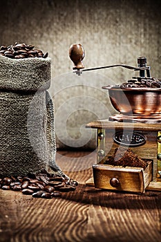 Coffee mill and burlap sack with coffee beans