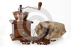 Coffee mill with burlap sack of roasted beans